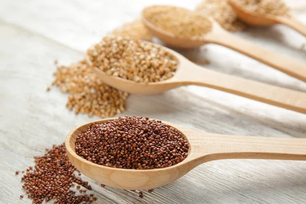 Quinoa seeds in wooden spoons — Stock Photo, Image