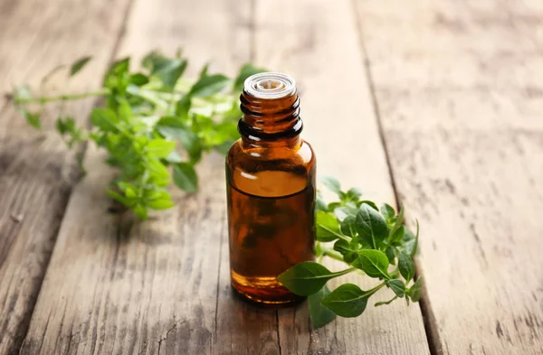 Glass bottle with oregano oil — Stock Photo, Image