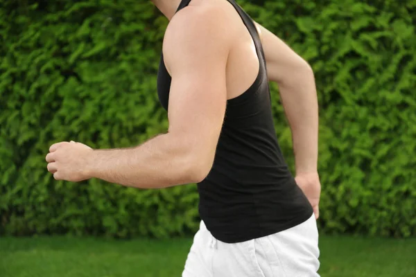 Sporty man running outdoors — Stock Photo, Image