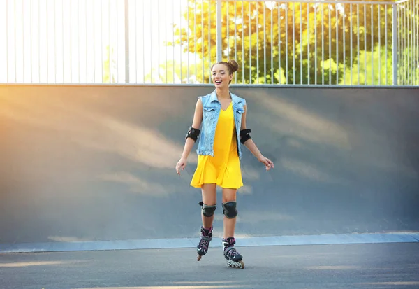 Young woman rollerskating outdoors — Stock Photo, Image