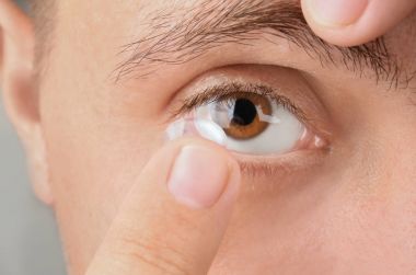 Onun gözünde koyarak Kontakt lens genç adam