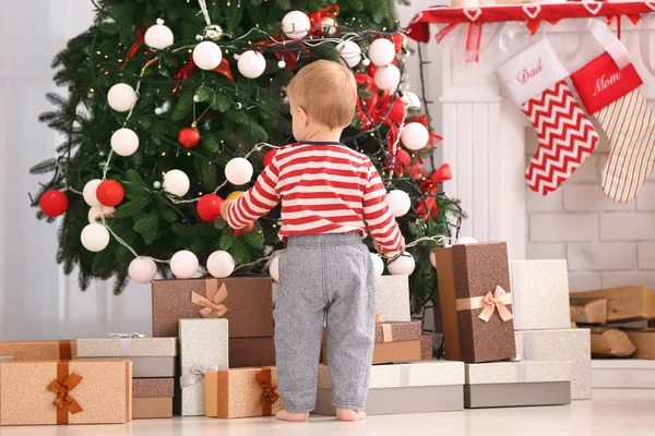 Cute little baby in room decorated for Christmas — Stock Photo, Image
