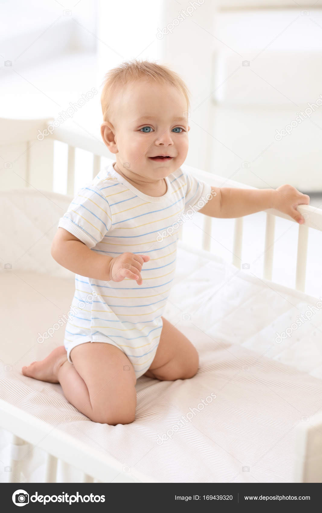Cute little baby in crib at home — Stock Photo © belchonock 169439320
