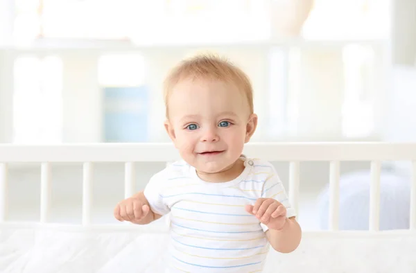 Söt liten bebis i barnsäng hemma — Stockfoto