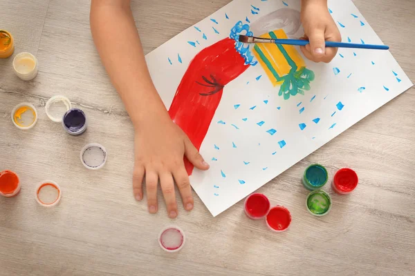 Girl painting Christmas picture on floor — Stock Photo, Image