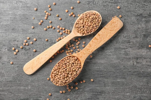 Spoons with healthy lentils — Stock Photo, Image
