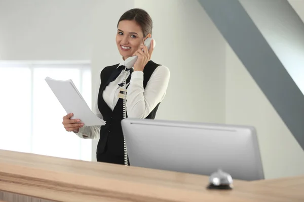Recepcionista feminina falando ao telefone no hotel — Fotografia de Stock