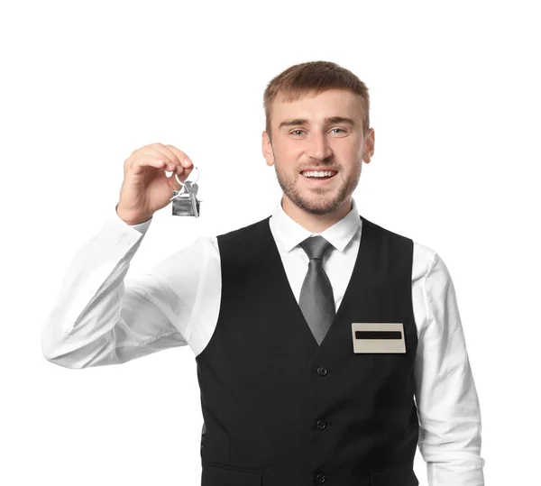 Mannelijke hotelreceptionist met kamersleutel op witte achtergrond — Stockfoto