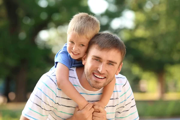 Happy man with son in park on sunny day — Stock Photo, Image