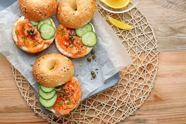 tasty salmon bagels on table