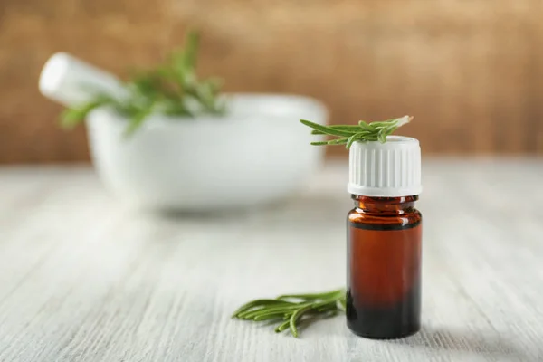 Bottle with rosemary oil and herb — Stock Photo, Image