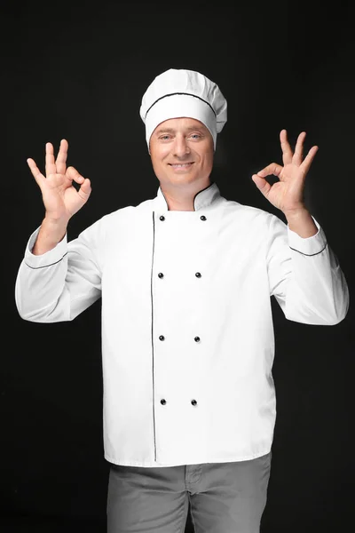 Male chef in uniform on black background — Stock Photo, Image