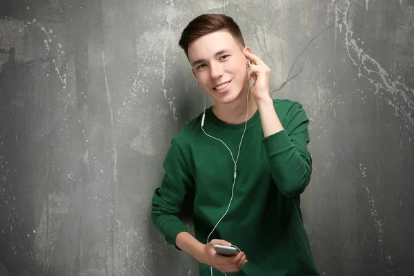Cute teenage boy on grunge background — Stock Photo, Image