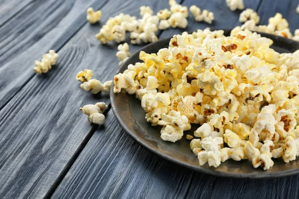 Popcorn on wooden table — Stock Photo, Image