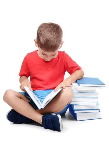 Cute little boy reading books on white background — Stock Photo, Image