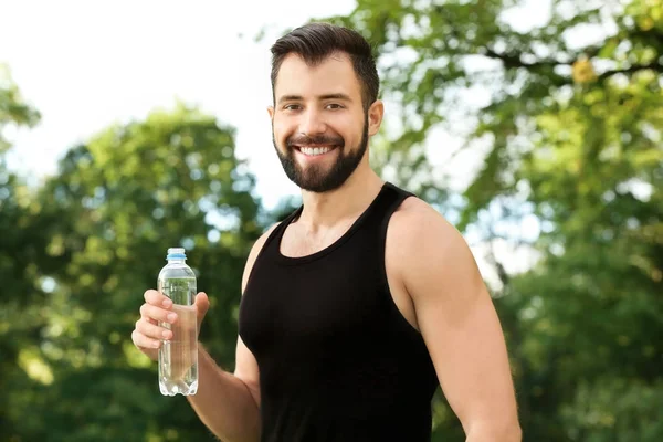 Young man with bottle of water — Stock Photo, Image