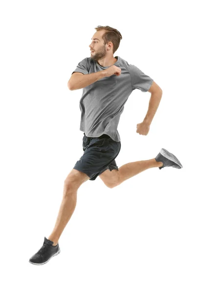 Joven en ropa deportiva corriendo sobre fondo blanco — Foto de Stock