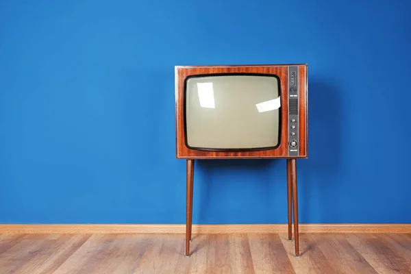 Old TV against color wall