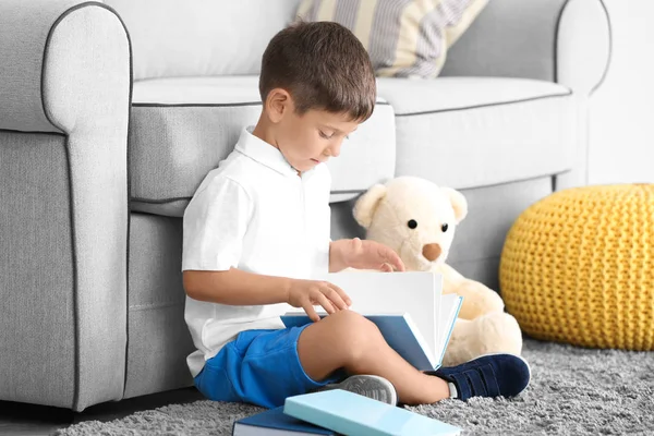 Cute little boy reading book at home — Stock Photo, Image