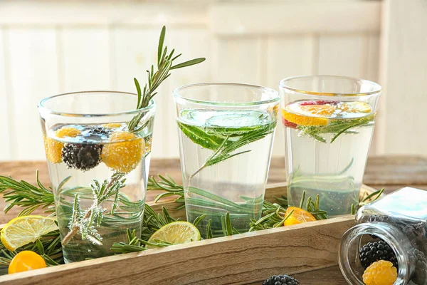 Glasses with rosemary drinks in wooden case — Stock Photo, Image
