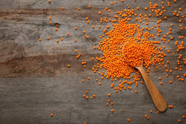 Lentils on wooden table — Stock Photo, Image