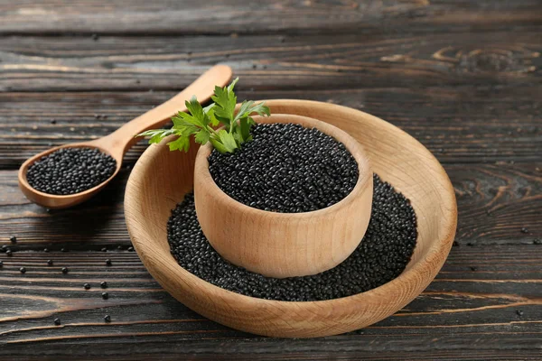 Composition with black lentils in kitchenware — Stock Photo, Image