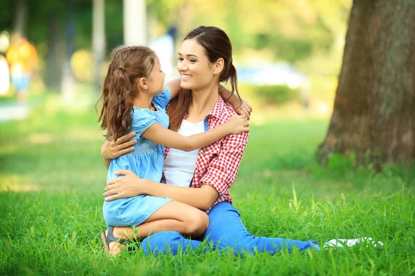 Menina bonito com a mãe no parque no dia ensolarado — Fotografia de Stock
