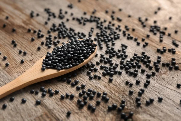 Lentils on wooden table — Stock Photo, Image