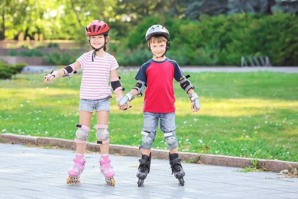 Active children rollerskating in park — Stock Photo, Image