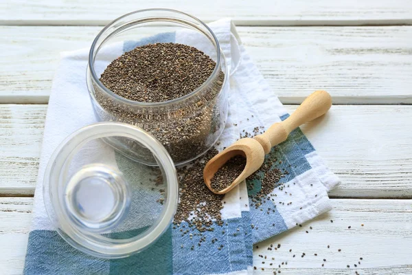 Chia seeds in jar and scoop on table — Stock Photo, Image