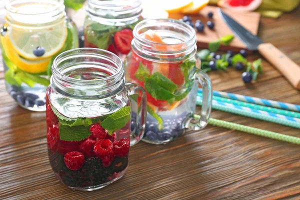 Mason jars of infused water with fruits — Stock Photo, Image