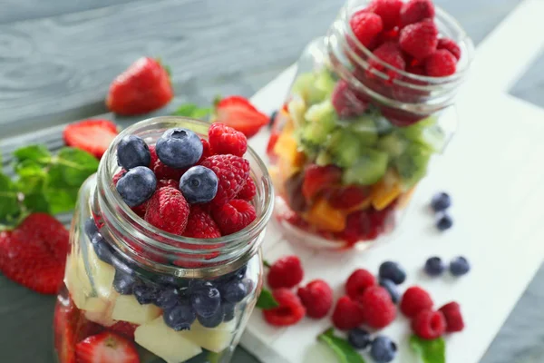 Jars with fruits and berries — Stock Photo, Image