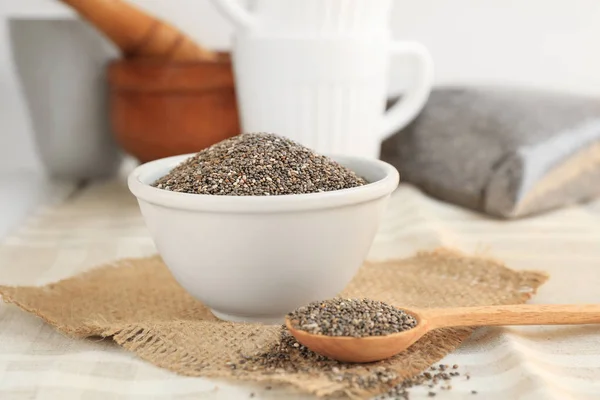 Chia seeds in spoon and bowl on table — Stock Photo, Image