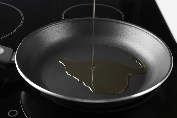 Pouring oil into frying pan