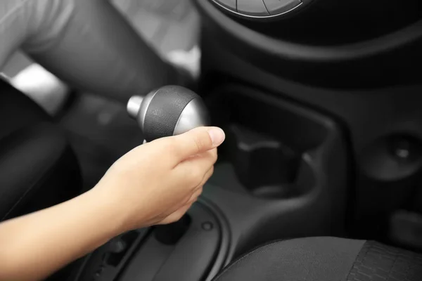 Woman pulling gearshift lever in car — Stock Photo, Image