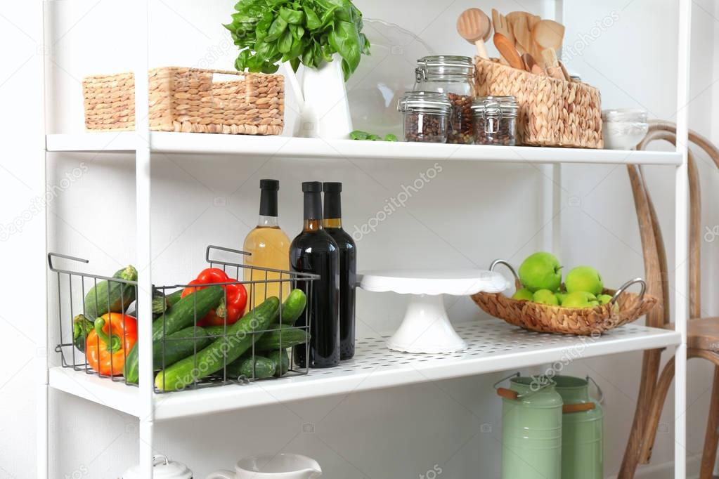 Storage stand with kitchenware and food stuff, indoors