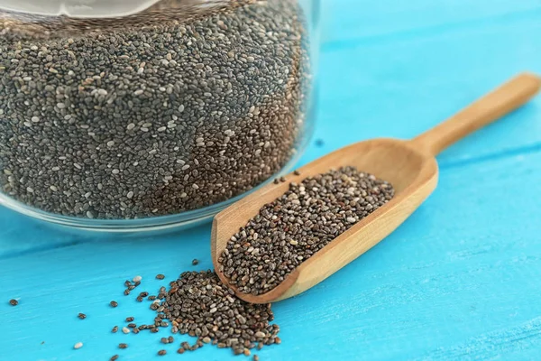 Chia seeds in scoop and jar on table — Stock Photo, Image