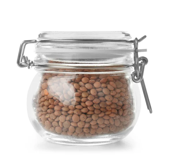 Glass jar with brown lentils on white background — Stock Photo, Image