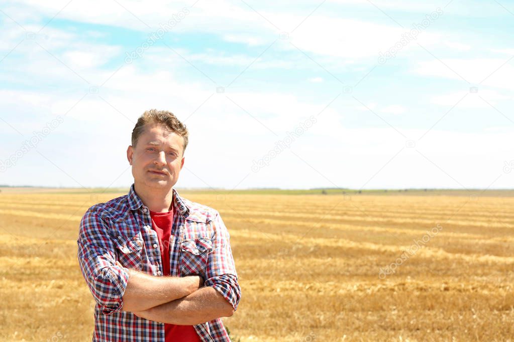 Mature farmer standing in field