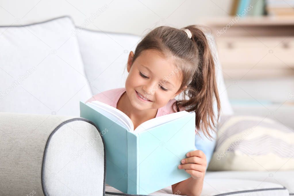 Cute little girl reading book 