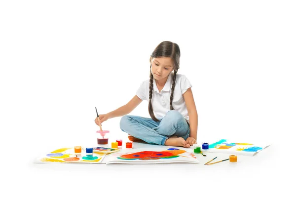 Little cute girl painting picture against white background — Stock Photo, Image