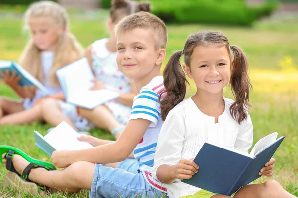 Śliczne małe dzieci, czytanie książek w parku — Zdjęcie stockowe
