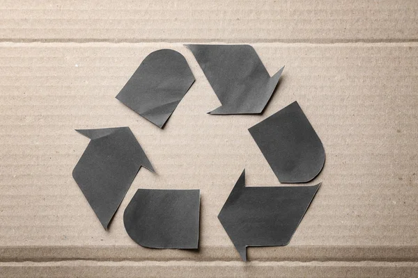 Symbol of recycling on cardboard background