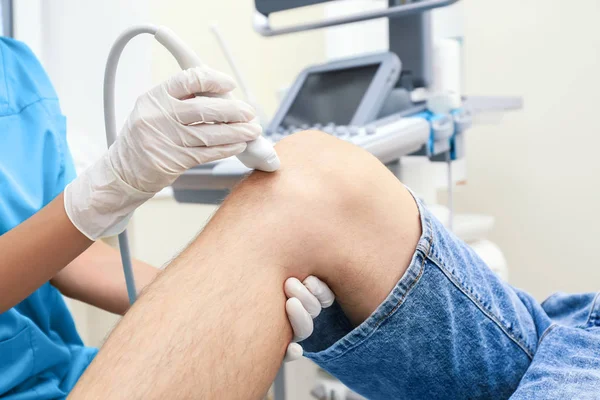 Doctor conducting ultrasound examination — Stock Photo, Image