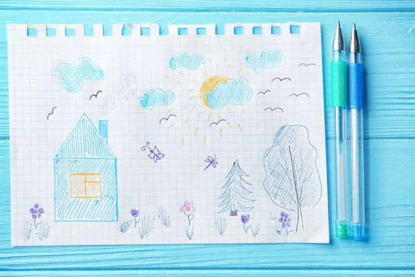 Child's drawing of house and trees on wooden background — Stock Photo, Image