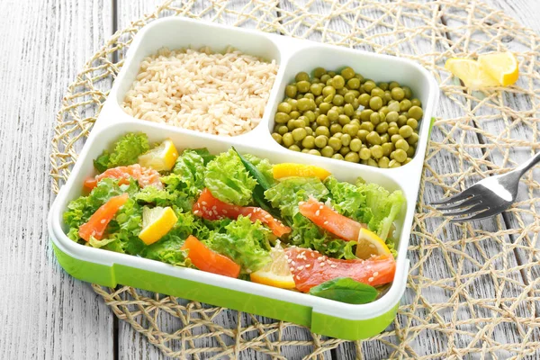 Lunch box with delicious salmon salad