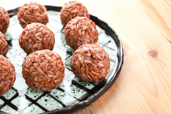 Plate with brown rice balls — Stock Photo, Image