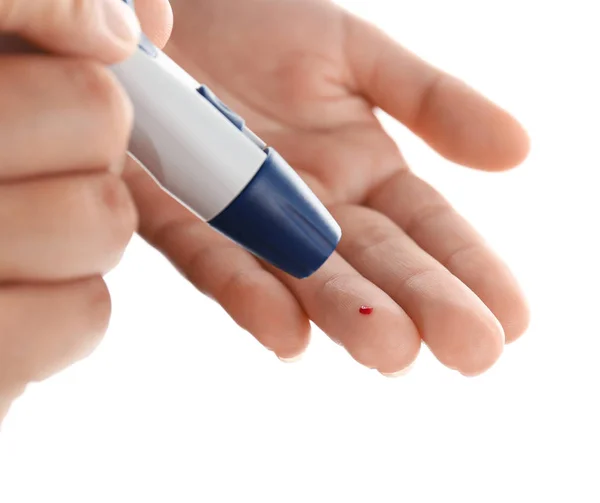 Woman taking blood sample with lancet pen — Stock Photo, Image