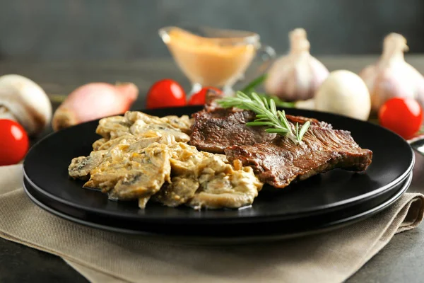 Plate with steak Diane on table — Stock Photo, Image