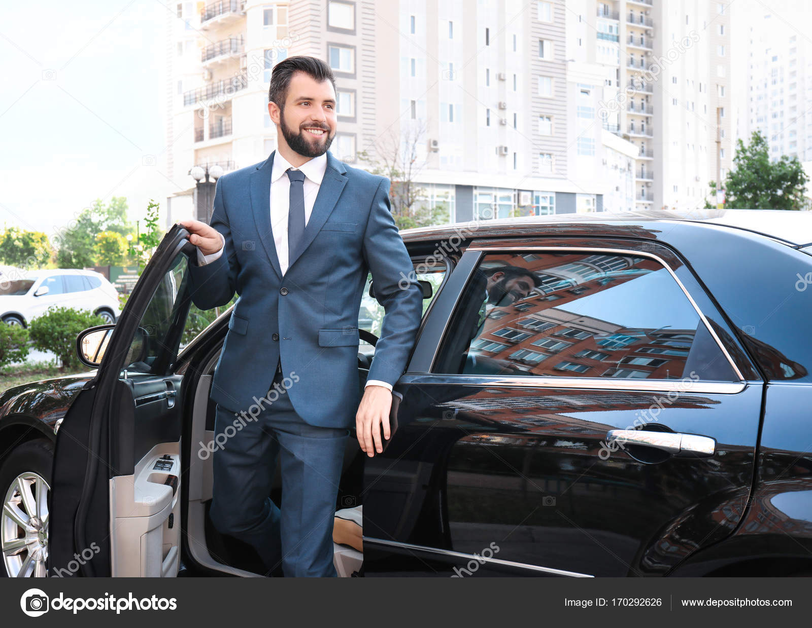Handsome man in suit getting out of car — Stock Photo
